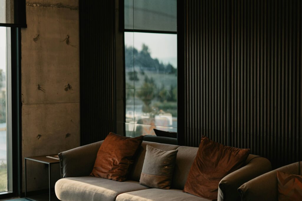 Dark modern living room with floor-to-ceiling windows